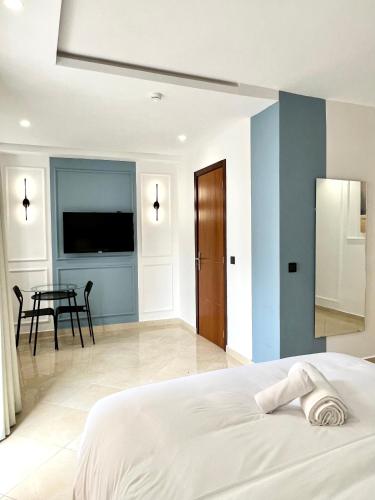 a bedroom with a bed and a dining room at MyCity in Rabat