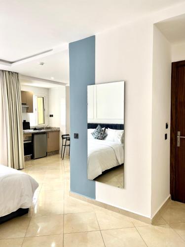 a bedroom with a bed and a mirror on a wall at MyCity in Rabat