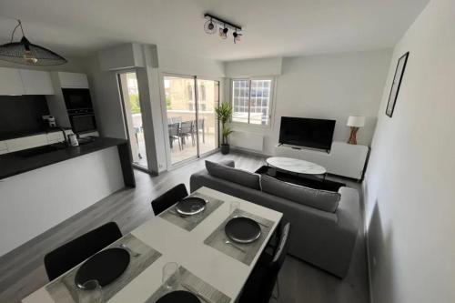 a living room with a couch and a table at Apartment hyper-center Biarritz with parking in Biarritz