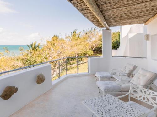 a living room with a view of the ocean at Villa Santorini in Vilanculos