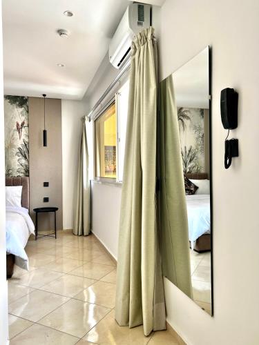 a bedroom with a mirror and a bed and a window at MyCity in Rabat
