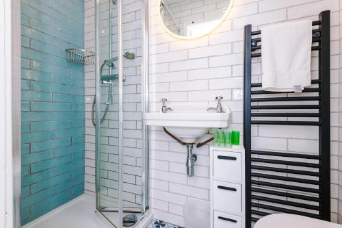 a bathroom with a sink and a shower at Stylish Home with Canal Views in Chester