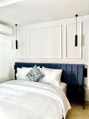 a bedroom with a blue and white bed with white pillows at MyCity in Rabat