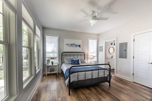 a bedroom with a bed and a ceiling fan at Captain's Cove in Eatonton