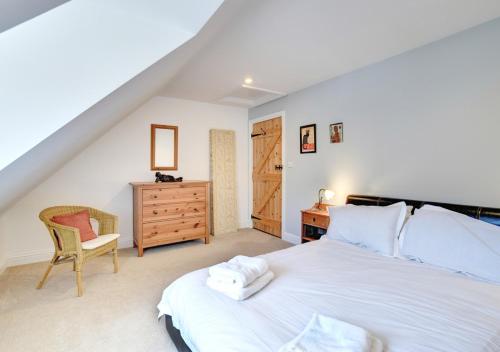 Schlafzimmer mit einem Bett, einem Schreibtisch und einem Stuhl in der Unterkunft Amrose Cottage in Blythburgh