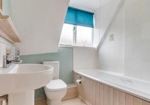 a bathroom with a sink and a toilet and a tub at Anchor Cottage in Woodbridge