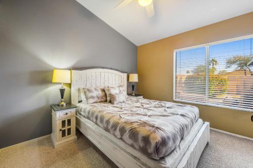 a bedroom with a large bed and a window at Palm Valley Oasis in Goodyear
