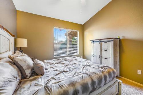 a bedroom with a bed and a window at Palm Valley Oasis in Goodyear