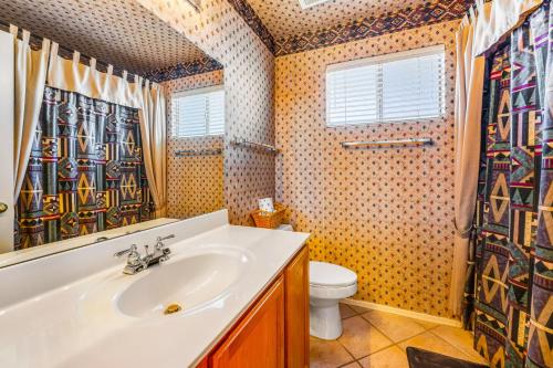 a bathroom with a sink and a toilet at Palm Valley Oasis in Goodyear