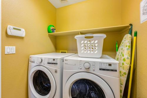 a laundry room with a washer and dryer at Palm Valley Oasis in Goodyear