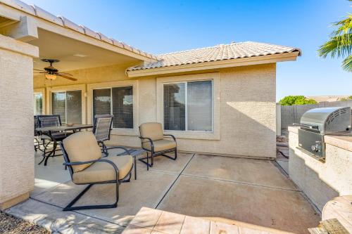a patio with chairs and a table and a grill at Palm Valley Oasis in Goodyear