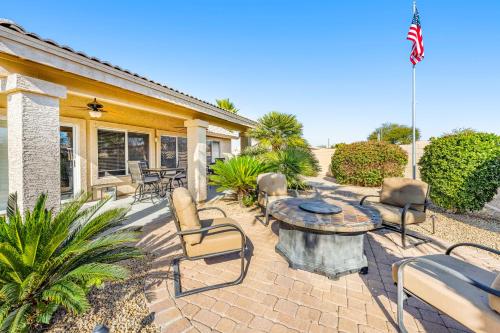 a patio with a table and chairs and a flag at Palm Valley Oasis in Goodyear