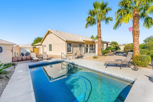 a swimming pool with palm trees and a house at Palm Valley Oasis in Goodyear