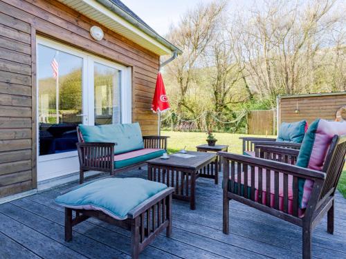 un patio avec trois bancs et une table et une fenêtre dans l'établissement Holiday Home Chez Laurette by Interhome, à Saint-Laurent-sur-Mer