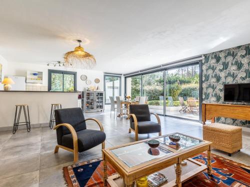 a living room with a table and chairs at Holiday Home Les Narcisses by Interhome in Ronce-les-Bains