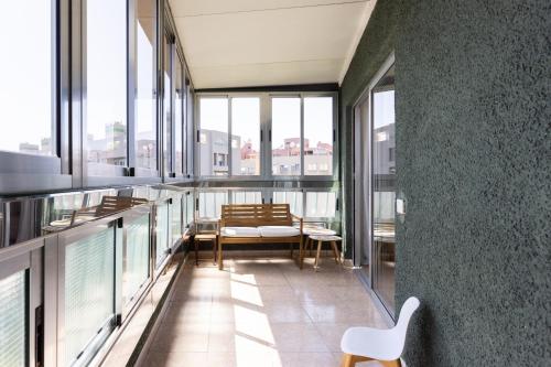 a balcony with chairs and windows in a building at EDEN RENTALS Kings Kapital in Santa Cruz de Tenerife