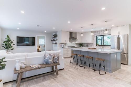 a kitchen and living room with a couch and a table at Indies Pool Paradise in Jupiter