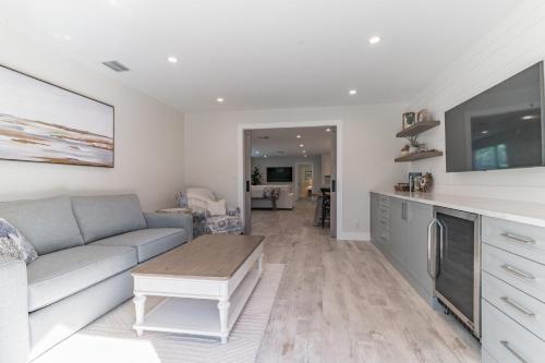 a living room with a couch and a table at Indies Pool Paradise in Jupiter