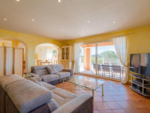 a living room with two couches and a television at Villa La Figuière by Interhome in La Nartelle