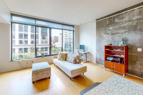 a living room with a couch and a large window at Life is Grand in Los Angeles