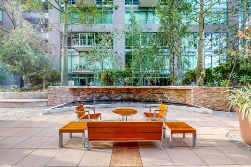 a patio with a table and chairs in front of a building at Life is Grand in Los Angeles