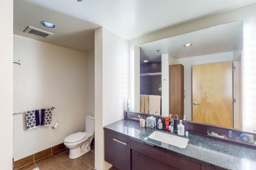 a bathroom with a sink and a toilet and a mirror at Life is Grand in Los Angeles