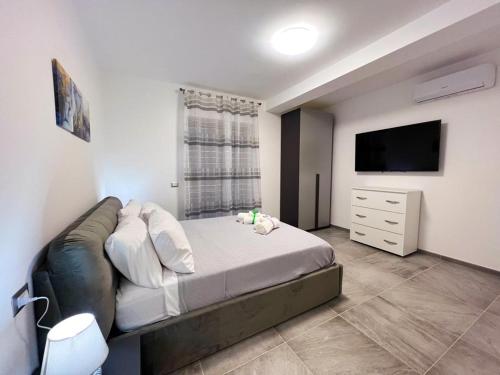 a bedroom with a bed and a flat screen tv at La Catena in Gaeta