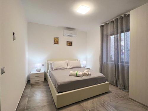a small bedroom with a bed and a window at La Catena in Gaeta