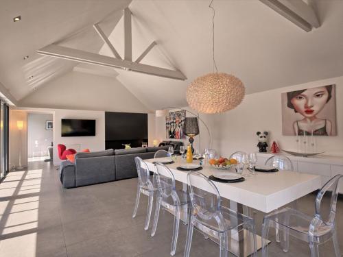 a kitchen and living room with a table and chairs at Holiday Home Villa Noalou by Interhome in Arzon