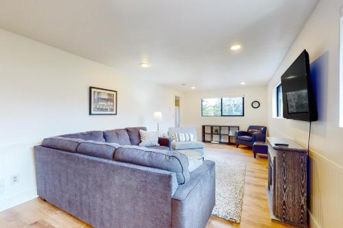 a living room with a large couch and a flat screen tv at The Canal Is Callin' in Union