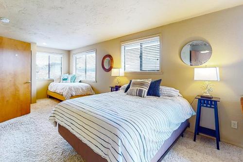 a bedroom with two beds and a mirror and windows at The Canal Is Callin' in Union