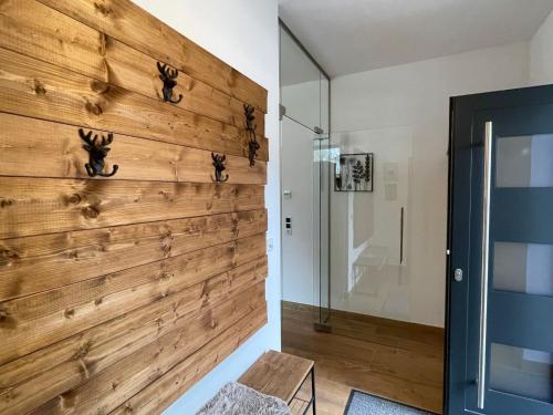 a large wooden wall in a room with a shower at Chalet Wildenbach by Interhome in Grafenweg