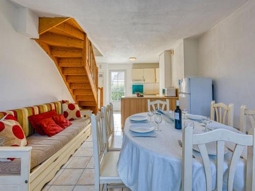 a dining room with a table and a couch at Holiday Home Les Grandes Bleues 3 by Interhome in Narbonne-Plage