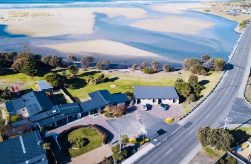 an aerial view of a house next to a highway at Pelican Sands Scamander in Scamander