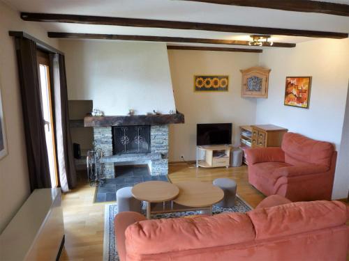 sala de estar con sofá y chimenea en Chalet Praline by Interhome, en Icogne