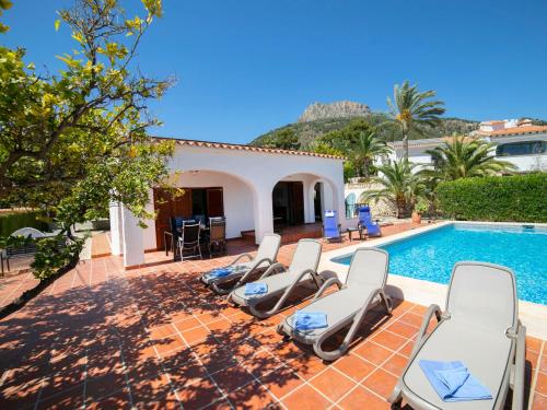 a group of chairs sitting next to a swimming pool at Holiday Home Cecile by Interhome in La Canuta