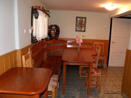a dining room with wooden tables and chairs at Holiday Home Life in Tryavna