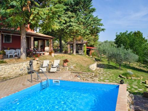 a swimming pool in front of a house at Holiday Home La Letizia by Interhome in Collemancio
