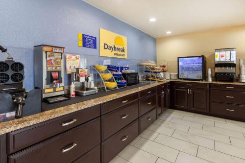 a fast food restaurant with a cash register and a counter at Travelodge by Wyndham Charles Town - Harpers Ferry in Charles Town