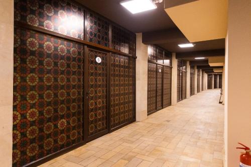 a hallway in a building with patterns on the walls at Qala Hostel Ganja in Ganja