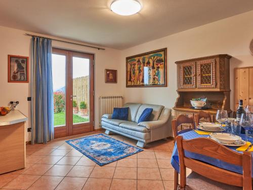 a living room with a couch and a table at Holiday Home Aaron by Interhome in Tremosine Sul Garda