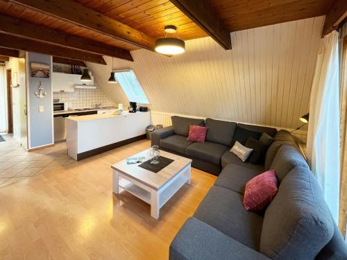 a living room with a couch and a table at Chalet Waldrauschen by Interhome in Bad Arolsen