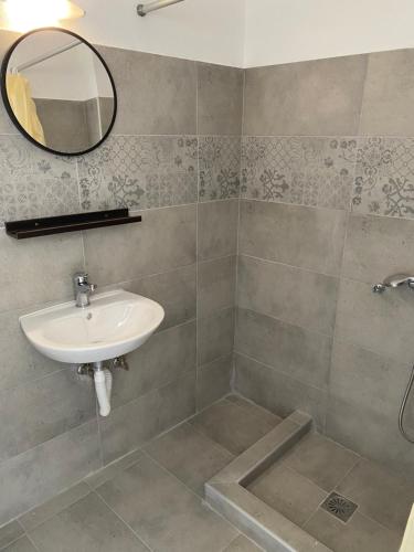 a bathroom with a sink and a mirror at Popi Studios in Kos Town