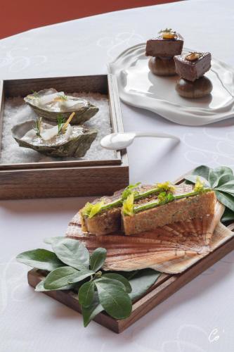a plate of food on a table with a plate of food at Georges Blanc Parc & Spa in Vonnas