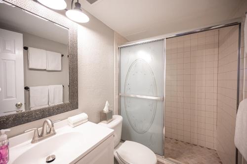 a bathroom with a toilet and a sink and a mirror at Stay Together Suites on The Strip - 2 Bedroom Condo 926 in Las Vegas