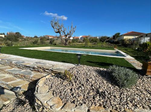 a swimming pool in the middle of a yard at L'Escale au Portugal Villa-B&B-Spa in Ataíja de Baixo