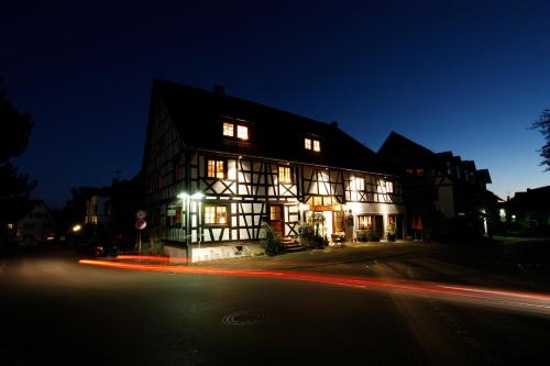a lit up building on a street at night at Villa Puppenhaus in Immenstaad am Bodensee