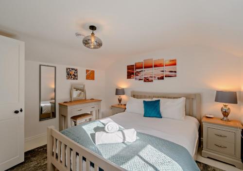 a bedroom with a bed and two night stands at Harbour Cottage - Ramsgate in Ramsgate