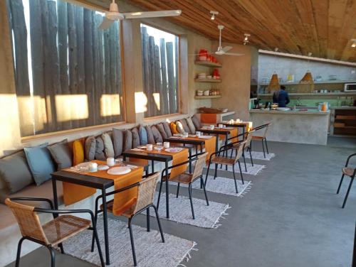 uma fila de mesas e cadeiras num restaurante em Cabanas de Melides em Melides
