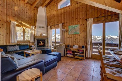 a living room with a couch and a fireplace at Chalet OnThePiste in La Tzoumaz